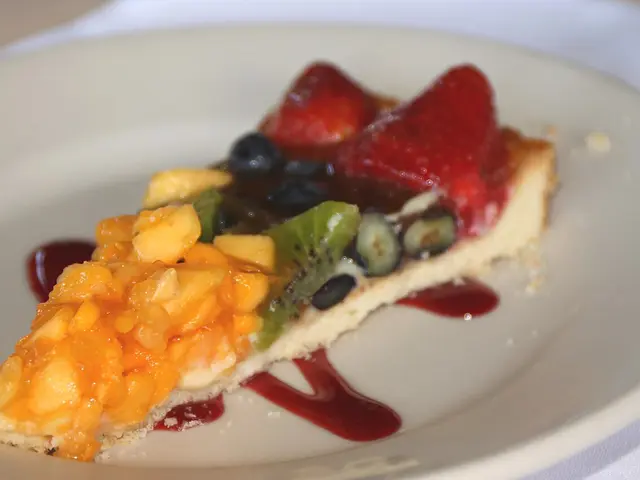 A fruit tart dessert plated at a restaurant table.