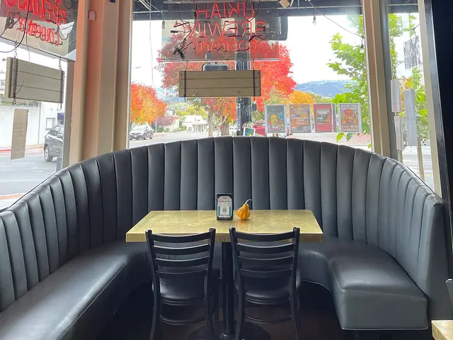 Interior seating area with tables and chairs at a brewery and restaurant.