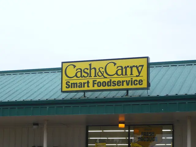 Exterior of a Cash & Carry Smart Foodservice wholesale food supply store, with stacked boxes of products near the entrance.