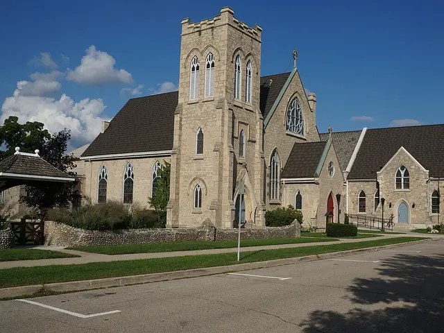 Exterior of Trinity Anglican Church in Cambridge, Ontario, a stone church with a square corner tower and steep gabled roof.
