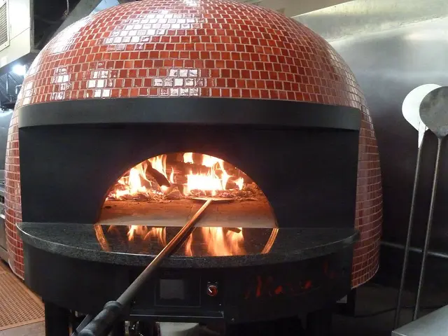 A modern wood-fired pizza oven at an Italian restaurant.