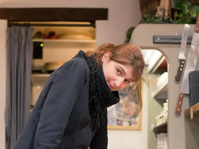 A shopkeeper cutting cheese inside a cheese shop in Paris.