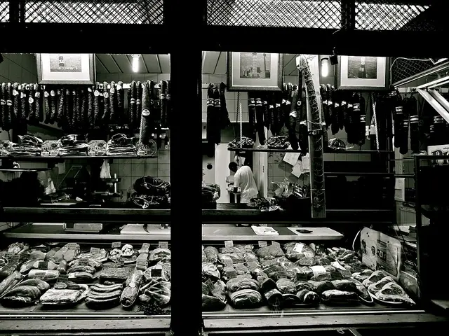 A delicatessen counter displaying an assortment of gourmet food products at a market hall.