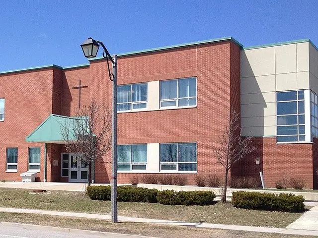 The exterior of All Saints Catholic Elementary School in Markham, Ontario, with a cross on the facade