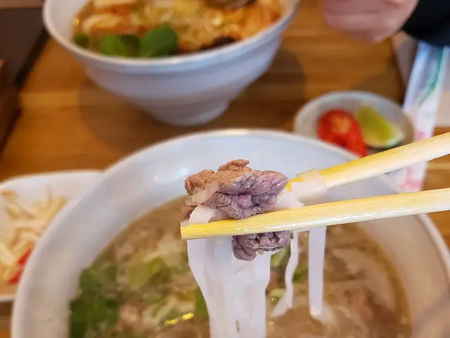 Close-up of a bowl of Vietnamese pho being eaten.