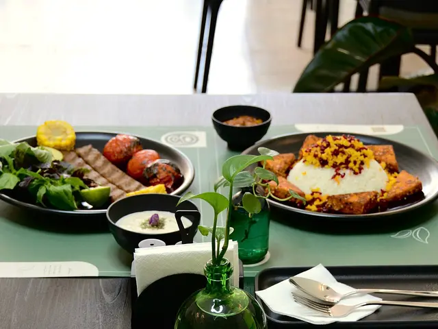 A Persian meal of grilled kebabs with saffron rice, grilled tomatoes, and side dishes.