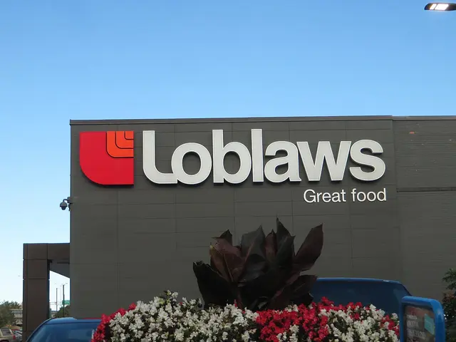 Loblaws supermarket sign on the exterior wall of an Ottawa store, with a flower planter below