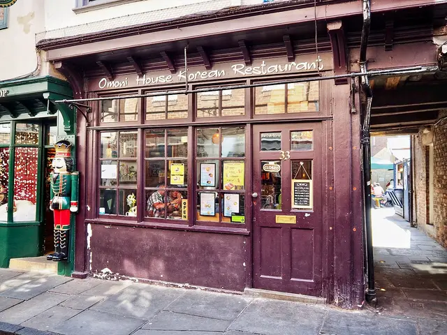 Exterior storefront of a Korean restaurant on a historic street.