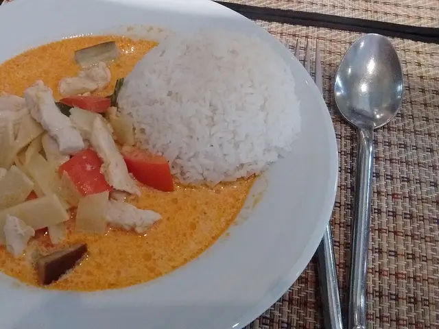 A plate of red chicken curry served at a Thai restaurant in Paris.