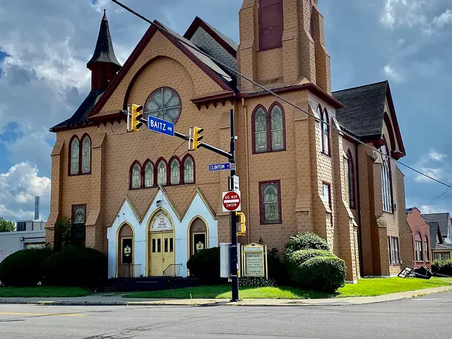 Exterior of the Greater Royal Worship Center, a Gothic Revival brick building with a corner tower, in Buffalo, New York.