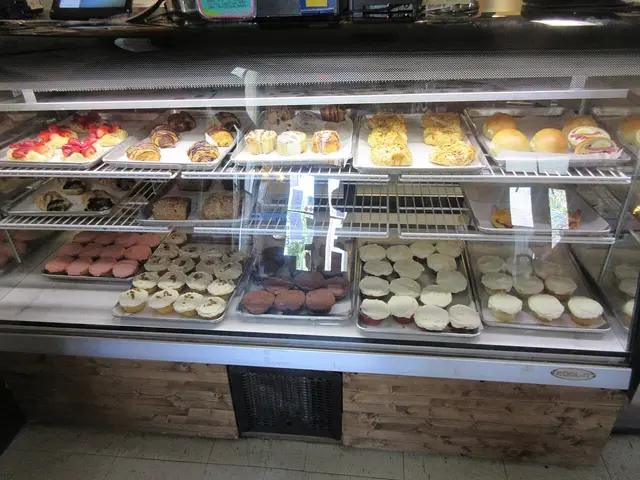 A bakery display case filled with cakes and pastries.