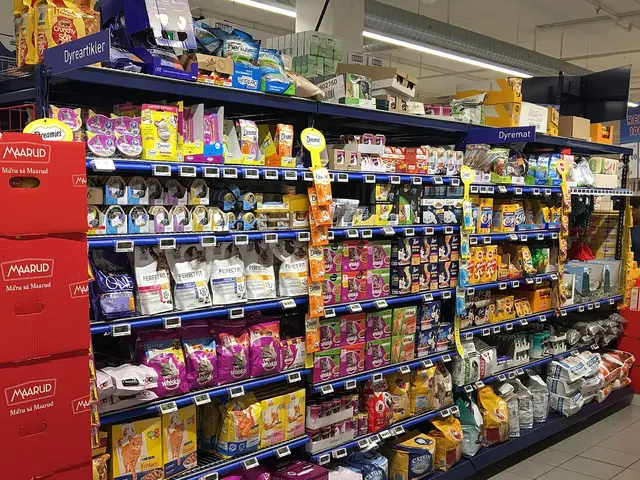 A grocery store aisle with shelves of pet food and pet supplies for sale.