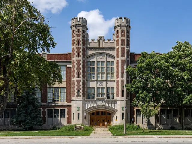 A historic collegiate-gothic high school building in Windsor, Ontario, with twin castellated towers