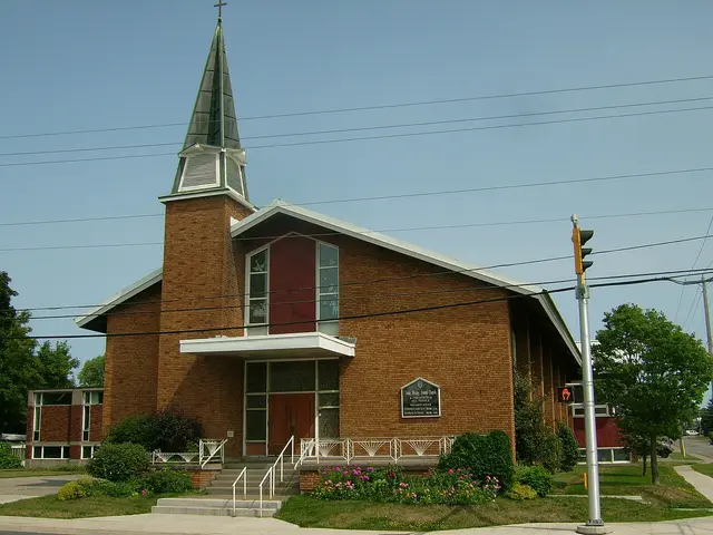 Brick John Wesley United Church with a tall steeple and a sign reading 'A Church for All People' in Sault Ste. Marie, Ontario.
