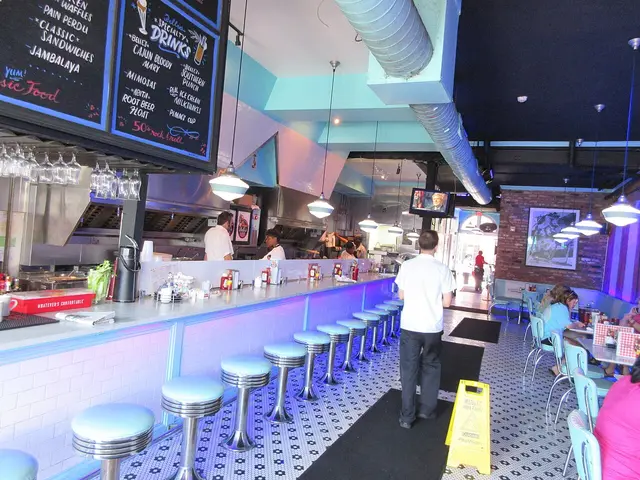 Counter stools along the service counter inside Belle's Diner in New Orleans.
