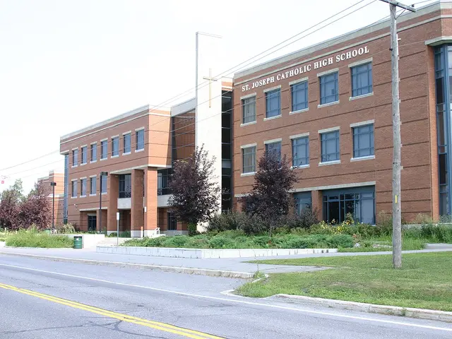 The brick exterior of St. Joseph Catholic High School in Ottawa, with a cross above the entrance and the school's name on the facade