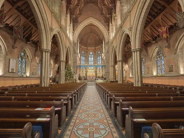 The exterior of a large stone parish church with a tower, photographed in an HDR style.