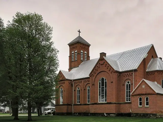 Exterior of Saint Mary Church, a brick church building with a bell tower in Kirby, Ohio.