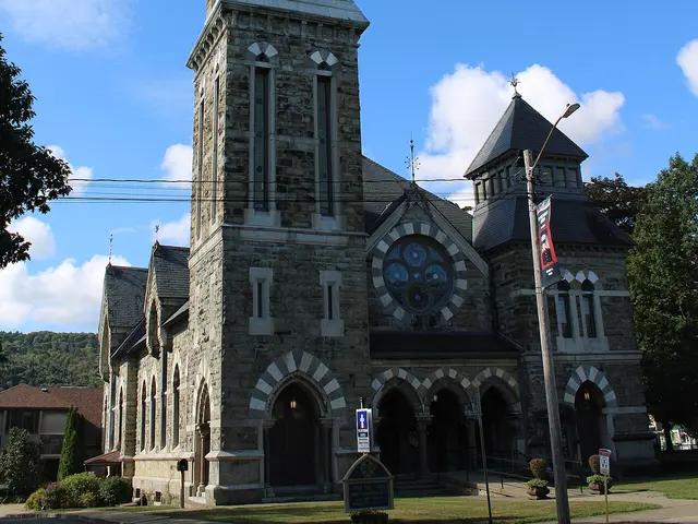 The First Presbyterian Church of Bath, New York, a stone Presbyterian church with a tall square bell tower and spire.