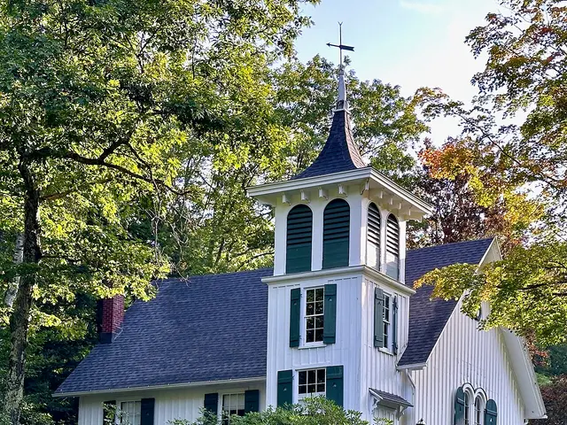 White wood-frame Church of Christ building with a square bell tower, surrounded by trees, in Mount Washington, Massachusetts.