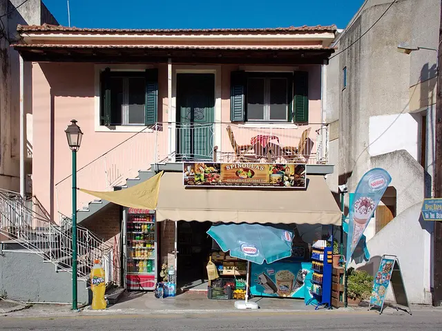 A small grocer's shop with an awning and an outdoor produce display in a seaside town on Corfu, Greece