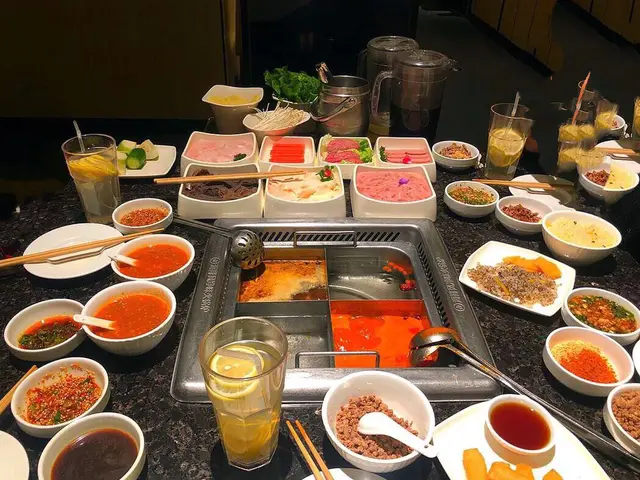 A hot pot meal with meat and vegetables at a Chinese restaurant.