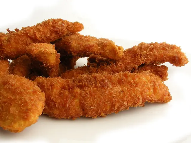 Crispy fried chicken strips served on a plate.