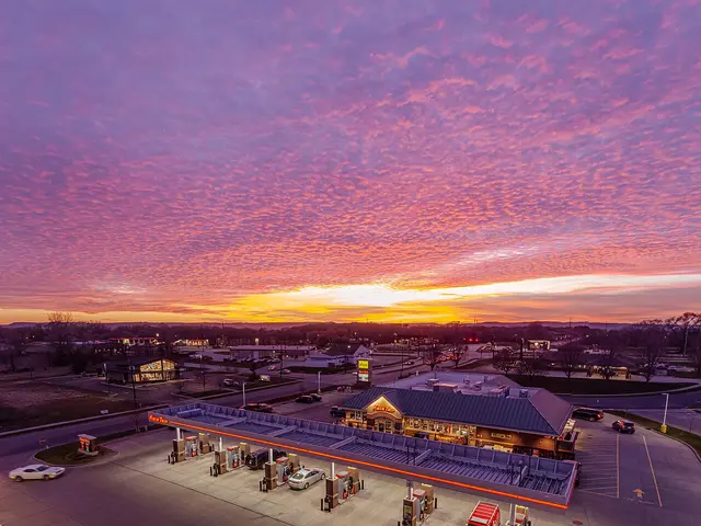Kwik Trip convenience store and fuel stop beneath a dramatic pink and purple sunset sky