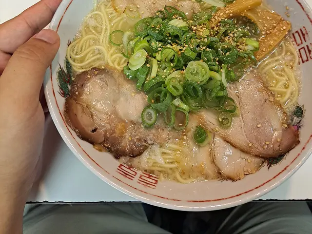 A bowl of shio ramen topped with sliced pork.
