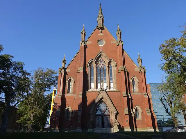 Exterior of the Presbyterian Church of Saint David, a red brick Gothic Revival building with a pointed spire, in Halifax, Nova Scotia.