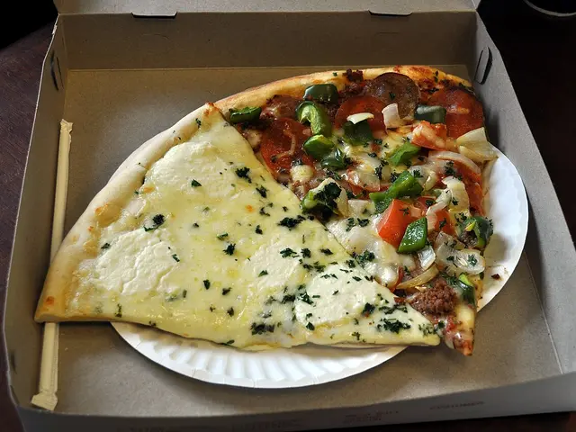 Two pizza slices on a plate, one white-style and one supreme-topped.