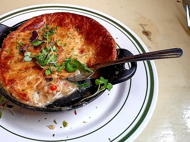 A seafood pot pie served on a plate at a restaurant.