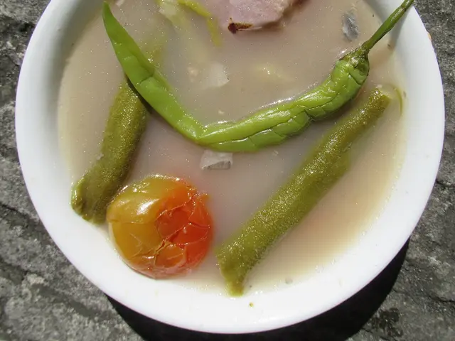A bowl of sinigang, a Filipino sour soup with fish.