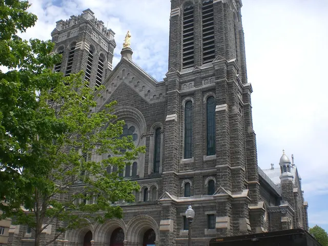 Exterior of St. Roch Church, a stone church building with a tall spire in Quebec City.