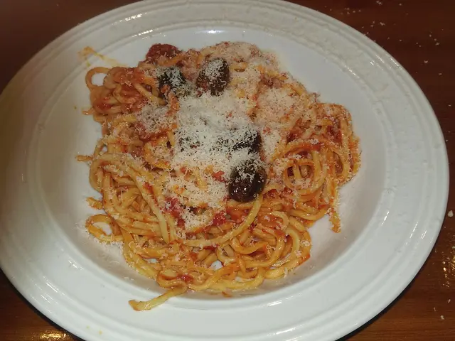 A plate of spaghetti alla chitarra with 'nduja and tomato sauce.