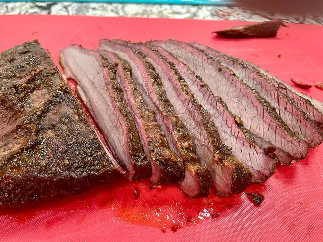 A smoked beef brisket with a visible smoke ring.