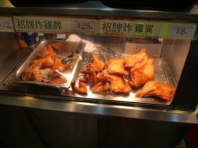 Fried chicken legs arranged on a display tray.