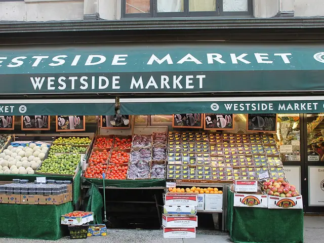 Fresh produce displayed outside a grocery store on the sidewalk.