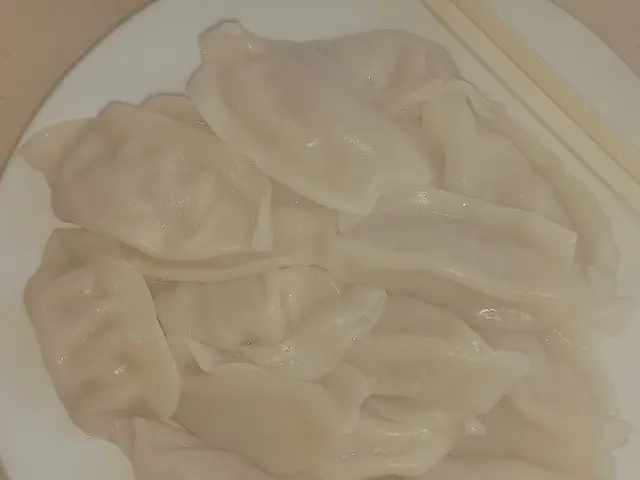 A plate of spicy pork jiaozhi dumplings from the Sichuan region.
