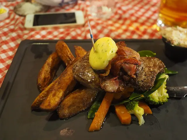 A plated steak dish served at a restaurant table.