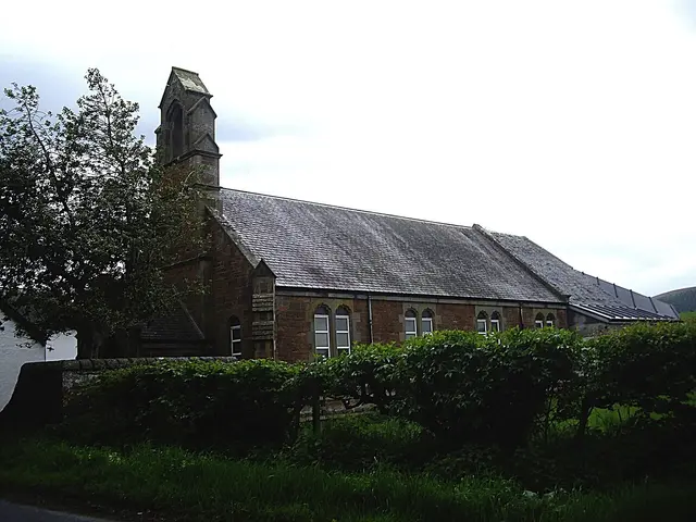 Exterior of a former place of worship building with a small stone bell tower, in Forgandenny, Scotland.