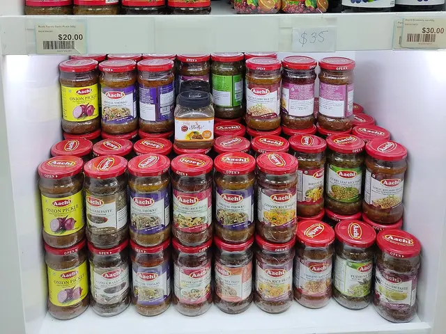 Interior aisle of Bhavika, a South Asian grocery store in a Tung Chung, Hong Kong shopping mall, lined with packaged goods.