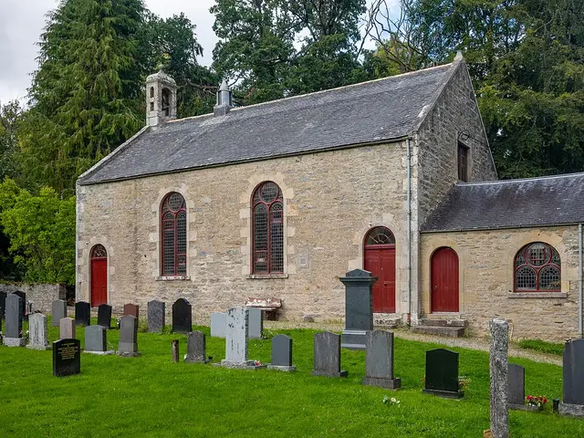 The exterior of a modern rectangular parish church building with a small bell tower.