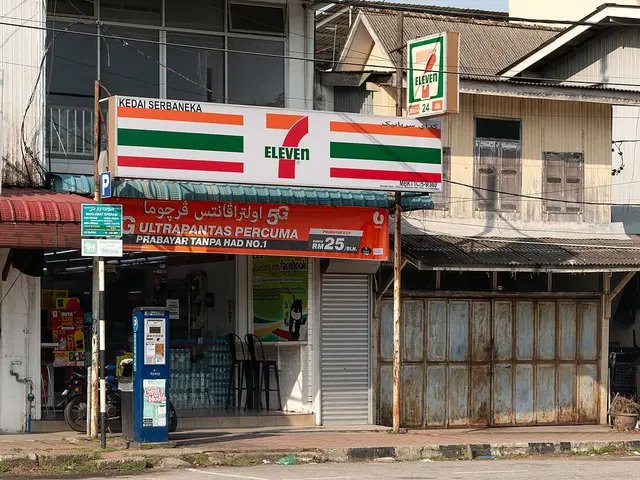 Exterior storefront of a 7-Eleven convenience store on a street in Kuala Terengganu, Malaysia.