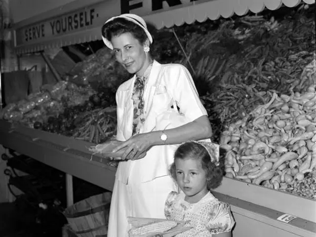 A shopper in the produce section of a grocery store.