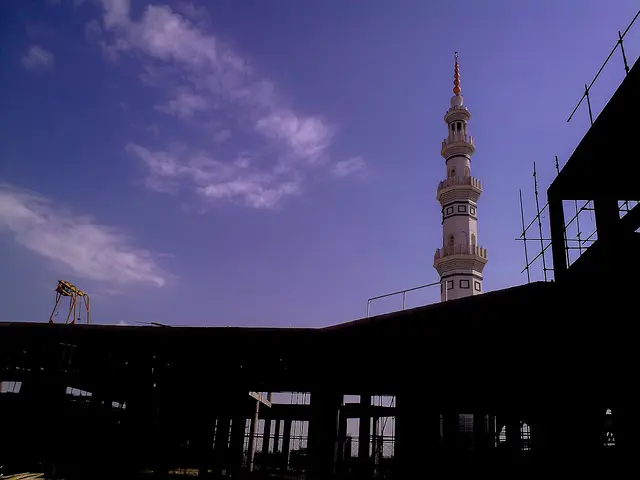 A mosque minaret silhouetted against the sky