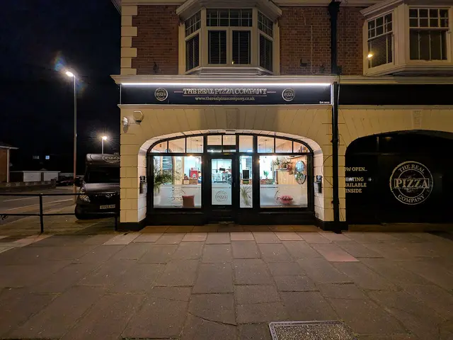 Exterior of a small pizza takeaway shop.