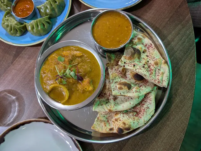 A stir-fried paneer jalfrezi curry with onions, bell peppers, and tomato from an Indian cafe.