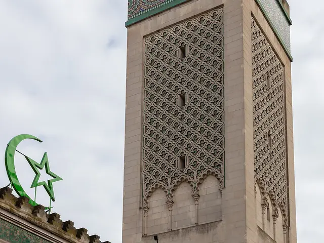 A mosque minaret with mosaic tilework