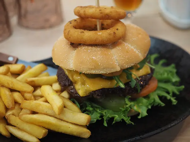 A burger served on a plate at a restaurant table.